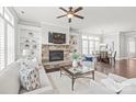 Open living space with stone fireplace, built-ins, and view to the adjacent dining area at 1209 Cedar Park Dr, Pineville, NC 28134