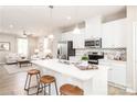 Modern kitchen with island and open view to living room at 1805 Woodlands Pointe Dr, Charlotte, NC 28216