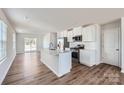 Modern kitchen featuring white cabinets, stainless steel appliances, and a large island at 1070 Old Trade St, Edgemoor, SC 29712