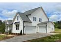 Beautiful home featuring a three-car garage, a well-maintained lawn, and a concrete driveway at 320 Triple Ponds Ct, Clover, SC 29710