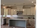 Modern kitchen featuring stainless steel appliances, a center island, and ample cabinet space at 320 Triple Ponds Ct, Clover, SC 29710