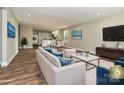 Open concept living area and kitchen with modern decor, hardwood flooring, and natural light at 409 Mint St, Rock Hill, SC 29730