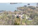 Expansive aerial view of a waterfront property featuring a modern home on a generous lot with mature trees at 8039 Mcconnell Rd, Denver, NC 28037