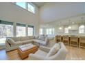 Bright living room with high ceilings, a large sectional sofa, and views of the kitchen and outdoor scenery at 8039 Mcconnell Rd, Denver, NC 28037
