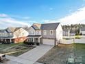 Two-story house with gray siding, a driveway, and a fenced backyard at 188 Water Ski Dr # 91, Statesville, NC 28677