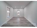 Spacious bedroom with hardwood floors and large windows at 221 Palmer St, Albemarle, NC 28001