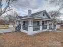 Renovated home showcasing side yard and landscaping at 221 Palmer St, Albemarle, NC 28001