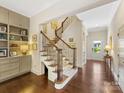 Elegant, curved staircase with wrought iron railing in a spacious foyer at 3364 Northampton Dr, Charlotte, NC 28210