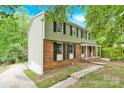 Two-story home boasts brick accents, siding, a covered porch, and a deck at 9106 Nash Ave, Charlotte, NC 28213