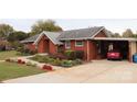 Brick ranch home with carport and landscaped yard at 129 Ann St, Salisbury, NC 28146