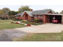 Brick ranch home with carport and landscaped yard at 129 Ann St, Salisbury, NC 28146