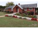 Brick ranch home with landscaped gardens and walkway at 129 Ann St, Salisbury, NC 28146
