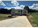 Charming new construction home featuring a gray exterior, dormer windows, and an attached two car carport at 184 Maplewood Ln, Taylorsville, NC 28681