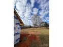 View from the side of a home construction site, showing the partially framed structure at 184 Maplewood Ln, Taylorsville, NC 28681