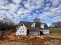 Exterior of the new construction home against a blue sky with scattered clouds at 184 Maplewood Ln, Taylorsville, NC 28681