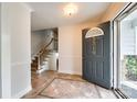 Bright foyer with stylish tile flooring, staircase, and a front door with the house number displayed at 3319 Mill Pond Rd, Charlotte, NC 28226