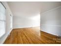 Spacious living room with gleaming hardwood floors, large windows, and neutral paint, perfect for entertaining at 3319 Mill Pond Rd, Charlotte, NC 28226