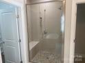 Modern shower with glass door, bench, and dual shower heads is the focus of this bright bathroom at 4033 Stadler Ne Dr # 22, Conover, NC 28613