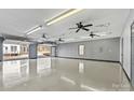 Spacious three-car garage with white epoxy flooring and fans at 116 Diamond Head Dr, Mooresville, NC 28117