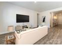 Bright living room has wood floors and minimalist design with a neutral color scheme at 1531 Harper Landing Blvd, Stanley, NC 28164