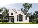 Rear view of a two-story farmhouse with large windows and patio at 2017 South St, Charlotte, NC 28208