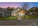 House exterior at dusk with landscaping and American flag at 226 Hickory St, Locust, NC 28097