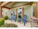 Front porch with blue chairs and landscaping at 226 Hickory St, Locust, NC 28097