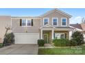 Two-story house with stone accents, a two-car garage, and a basketball hoop at 3960 Farmington Ridge Pkwy, Charlotte, NC 28213