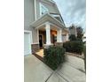 Inviting front porch with stone pillars and comfortable wicker chairs at 3960 Farmington Ridge Pkwy, Charlotte, NC 28213