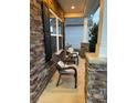 Cozy front porch with stone accents and two wicker chairs, perfect for relaxing at 3960 Farmington Ridge Pkwy, Charlotte, NC 28213