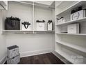 Well-organized walk-in closet featuring ample shelving, hanging space, and stylish designer shopping bags at 411 Newstyle Way # 4, Cramerton, NC 28056