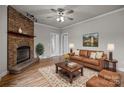 Living room with a stone fireplace and a brown leather sofa at 4759 Mel Nunnery Rd, Fort Lawn, SC 29714