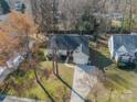 An aerial view of a charming single Gathering home with a one car garage, driveway and front lawn at 5218 Haybridge Rd, Charlotte, NC 28269