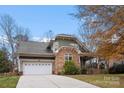 House exterior showcasing stone, siding, and a two-car garage at 7708 Spanish Oaks Dr, Waxhaw, NC 28173