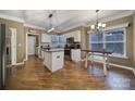 Kitchen with island, stainless steel appliances, and hardwood floors at 7721 Sedgebrook E Dr, Stanley, NC 28164