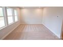 Spacious carpeted bedroom with large windows providing ample natural light at 7932 Cedarsmith Ct, Charlotte, NC 28217