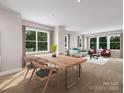 Bright dining room with large windows and wood dining table at 7932 Cedarsmith Ct, Charlotte, NC 28217