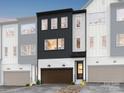 Modern townhome with dark gray and white exterior, 2-car garage, and front yard at 7932 Cedarsmith Ct, Charlotte, NC 28217