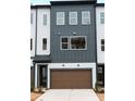 Modern townhome featuring a brown garage door, multiple windows, and neutral-colored siding at 7932 Cedarsmith Ct, Charlotte, NC 28217