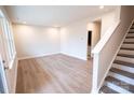 Empty room boasts recessed lights, wood floors and stairs leading to the upper level at 7932 Cedarsmith Ct, Charlotte, NC 28217