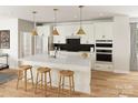 Modern kitchen with white cabinets, quartz countertops, and stainless steel appliances at 8008 Cedarsmith Ct, Charlotte, NC 28217