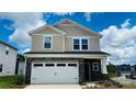 Beautiful two-story home boasts stone accents and a modern garage door, enhancing its architectural appeal at 827 Blue Canyon Dr, York, SC 29745