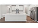 Bright kitchen features an island, stainless steel appliances, and white cabinetry at 827 Blue Canyon Dr, York, SC 29745