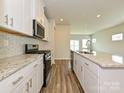 Modern kitchen with stainless steel appliances and granite countertops, creating a stylish cooking space at 827 Blue Canyon Dr, York, SC 29745