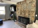 Living room with stone fireplace and hardwood floors at 8905 Vagabond Rd, Charlotte, NC 28227