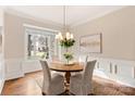 Formal dining room with a charming round table and ample natural light at 9042 Summer Club Rd, Charlotte, NC 28277