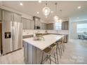 Modern kitchen with gray cabinetry, white quartz countertops, and stainless steel appliances at 12024 John Newton Dr # 41, Davidson, NC 28036