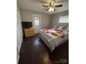 Cozy bedroom with dark hardwood floors, ceiling fan, and ample closet space at 1206 N Boyce St, Gastonia, NC 28052