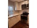 Modern kitchen featuring white cabinets, stainless steel appliances, and quartz countertops at 1206 N Boyce St, Gastonia, NC 28052