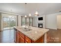 Kitchen island with granite countertops, stainless steel sink, and pendant lighting at 14509 Batteliere Dr, Charlotte, NC 28278